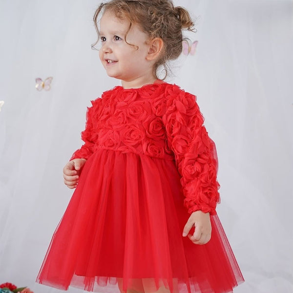 Child wearing a red dress with floral details against a white background